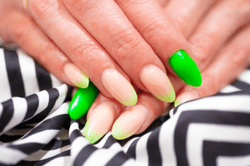 Close up of Fake Nails, Acrylic Nails, Gel nails on a woman's hand in neon colours